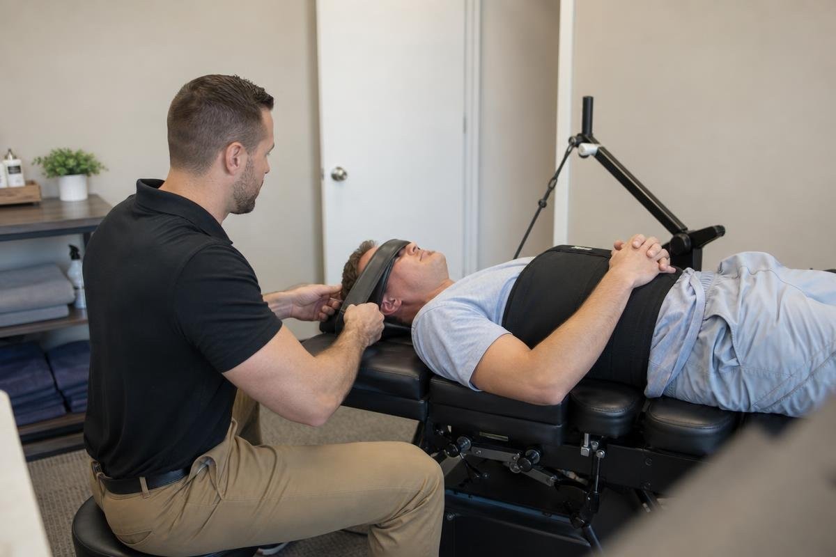 Practitioner adjusting a patient on a spinal decompression table