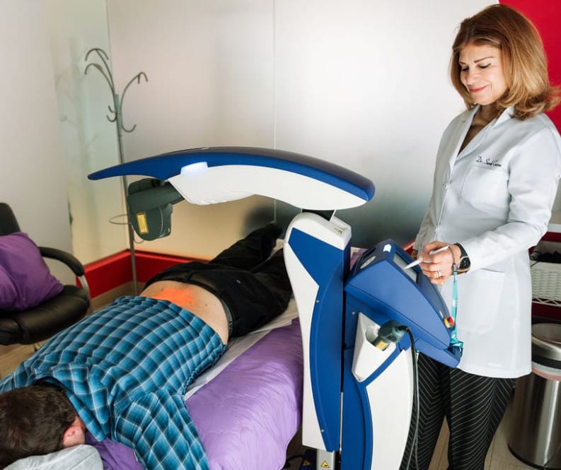 MLS laser therapy applied to a patient's shoulder