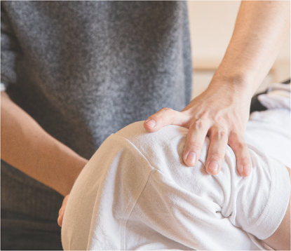 Provider reviewing cervical spine imaging in a clinic exam room
