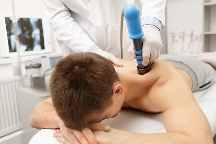 Extracorporeal shockwave therapy applied to a patient's lower leg